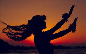 A woman is dancing in the sunset