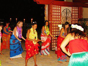 A group of women in colorful skirts dancing.