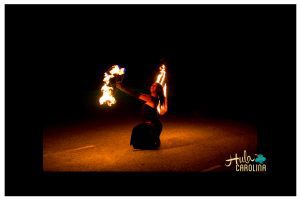 A woman is holding fire in the dark