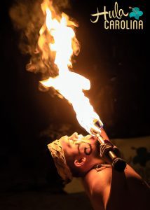 A person holding fire in the dark